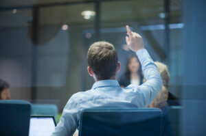 man raising hand