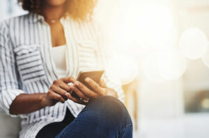 woman striped shirt phone